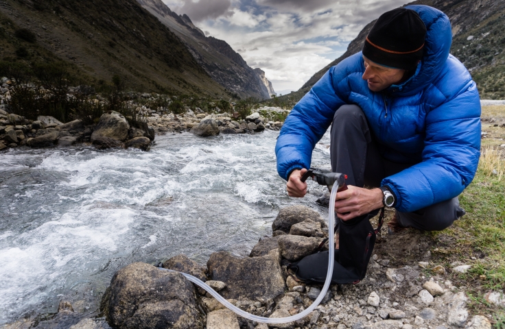 hiker with water filter